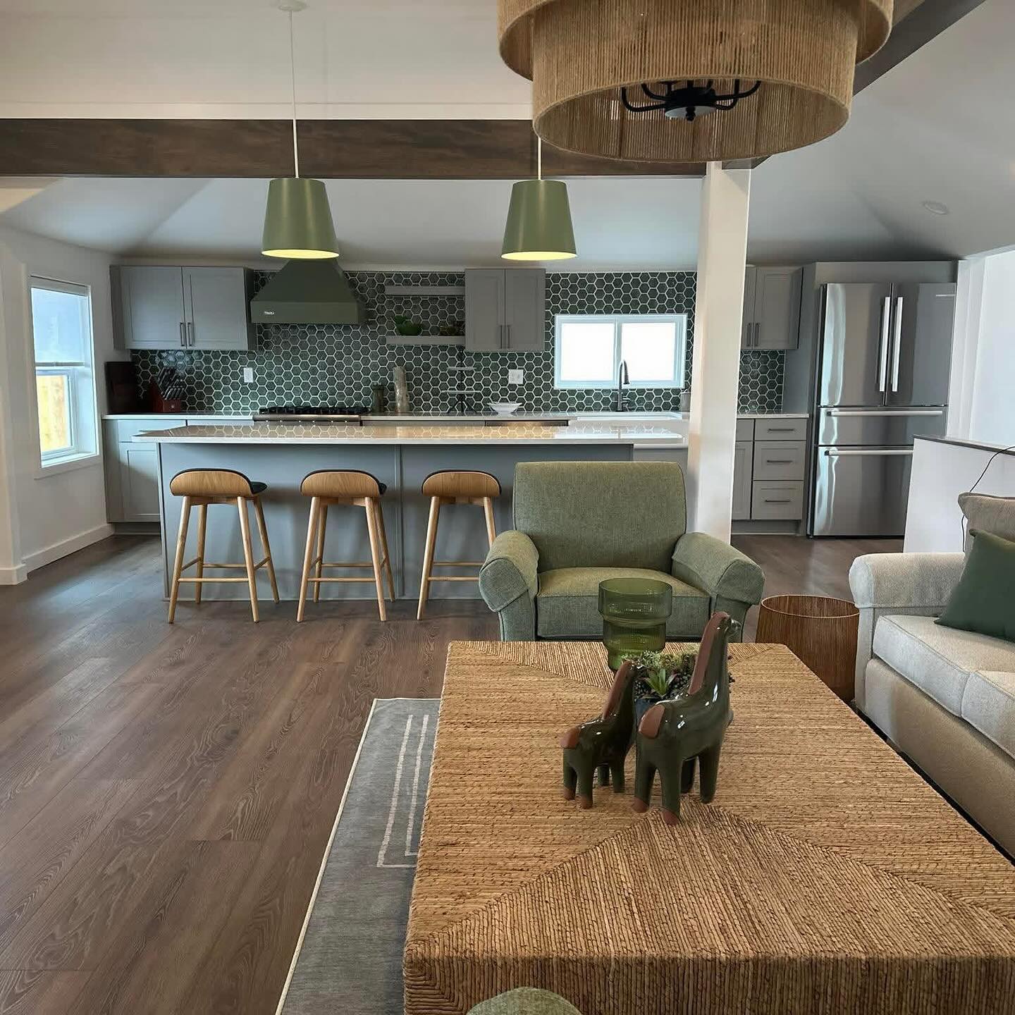 Warm open-plan living space from the Dave Squared photo archive, with wood table, timber beam and kitchen island.